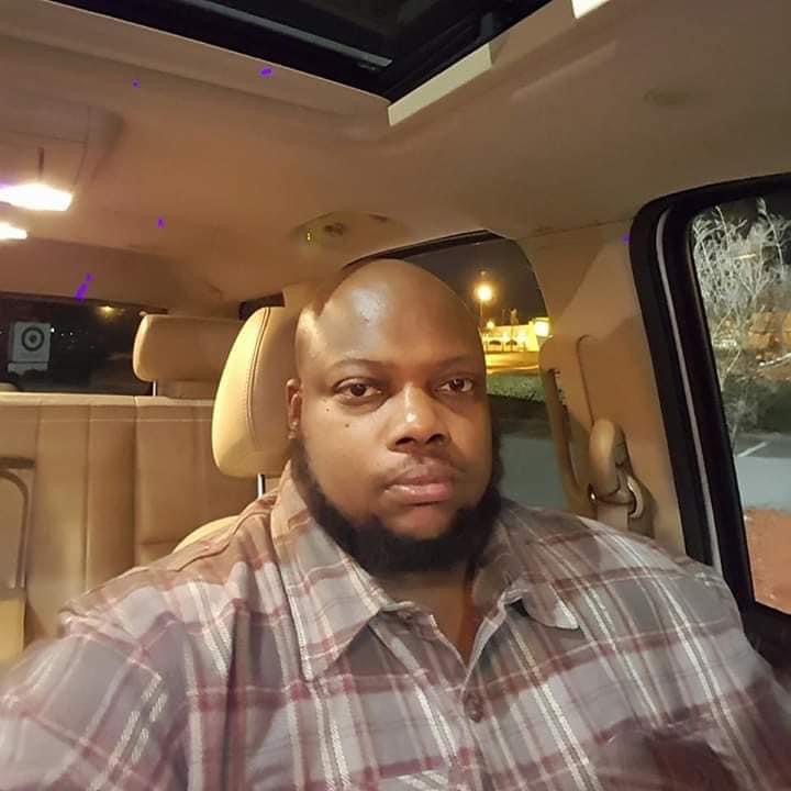 A picture of Shamekia Hill's brother in a car.