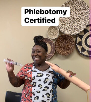 A picture of a woman recieving her Phlebotomy certification.